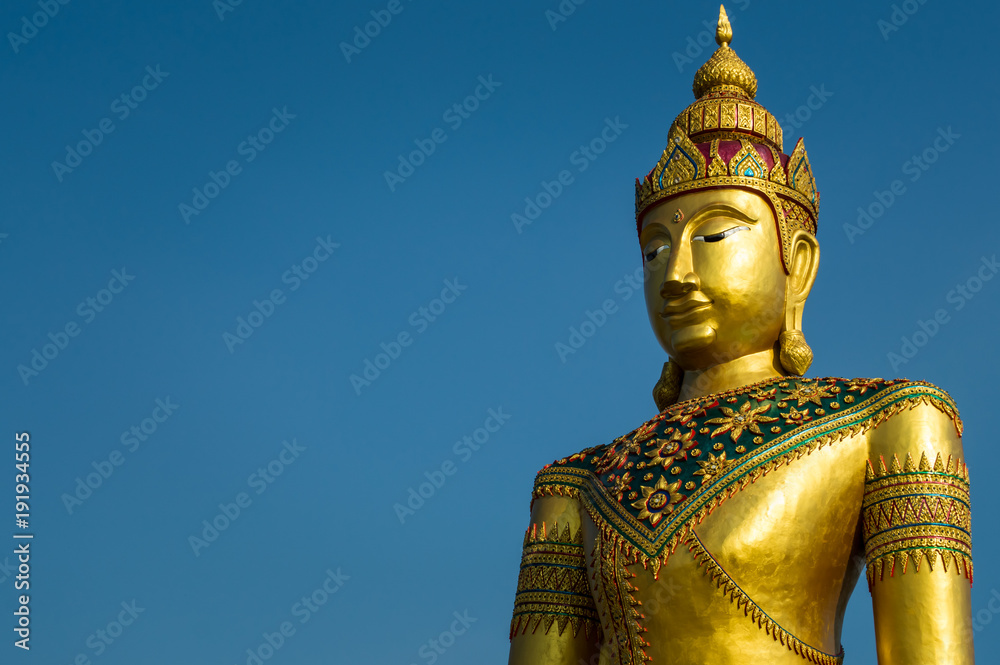 Golden image of buddha thai style on blue sky background Golden image of buddha thai style on blue sky background