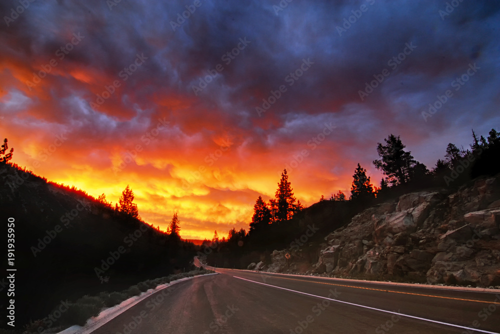 A sunset over a roadway in the Sierra Nevada mountains 
