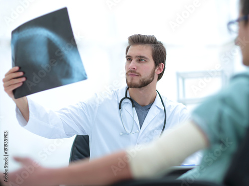 orthopedist examining a radiograph of a patient