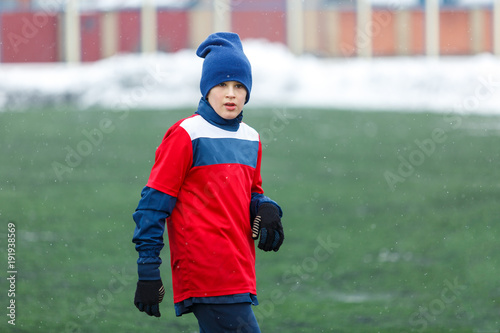 he is going to be a champion! kid plays football in hard winter conditions on the stadium