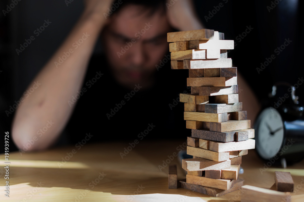 hand pull out block of wooden piece from stack strategy and risk concept hand pull out block of wooden piece from stack strategy and risk concept