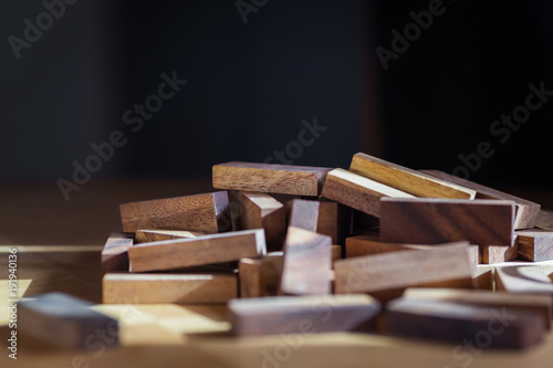 heap of wooden block on table with black background