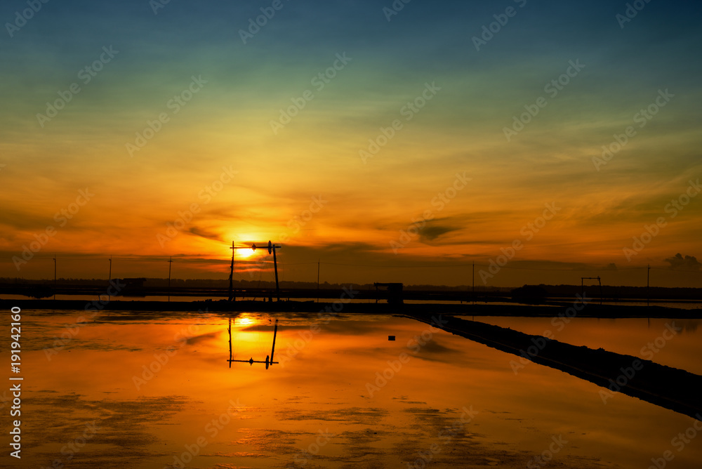 Beautiful Sunrise over windmill at salt farm, Thailand