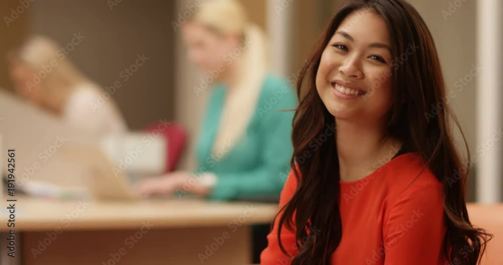 4K Portrait of attractive businesswoman smiling to camera, with staff working in background. Slow motion. 4K Portrait of attractive businesswoman smiling to camera, with staff working in background. Slow motion.