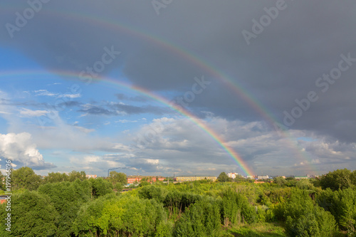 Fototapeta Naklejka Na Ścianę i Meble -  Beautiful double rainbow over summer city
