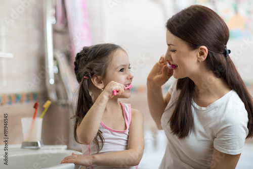 Little child girl and mom b...