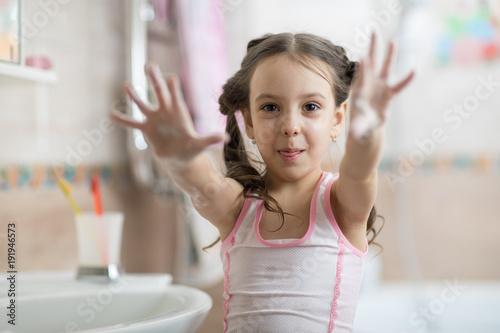 child washing hands and sho...