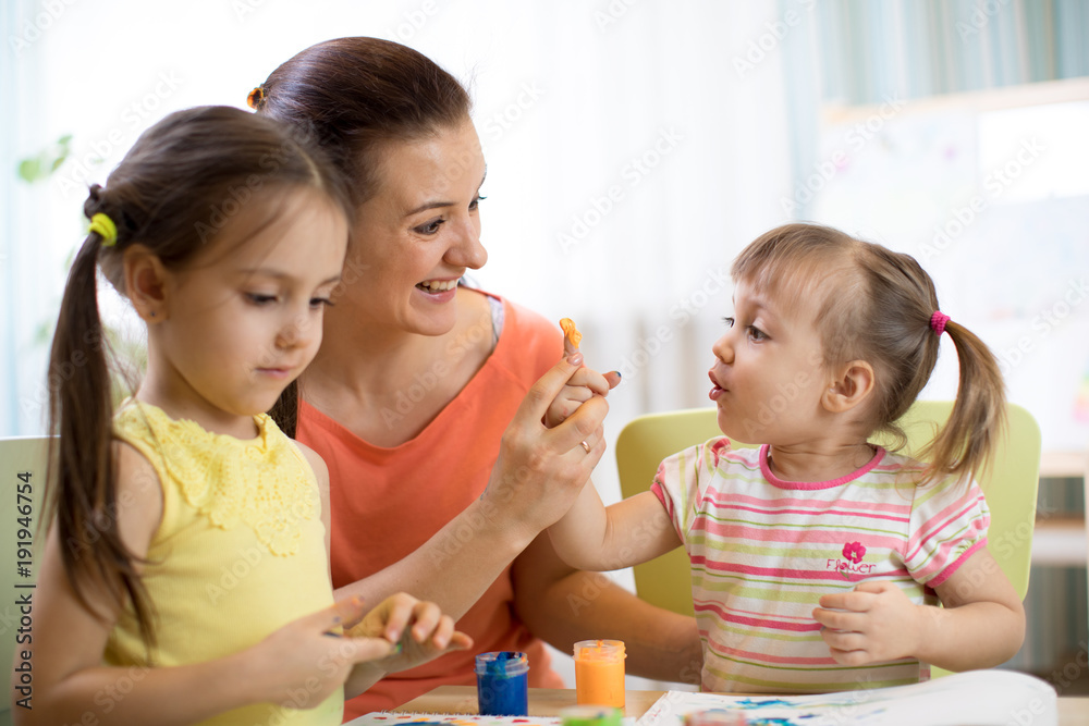 Children and mother with finger paints Children and mother with finger paints