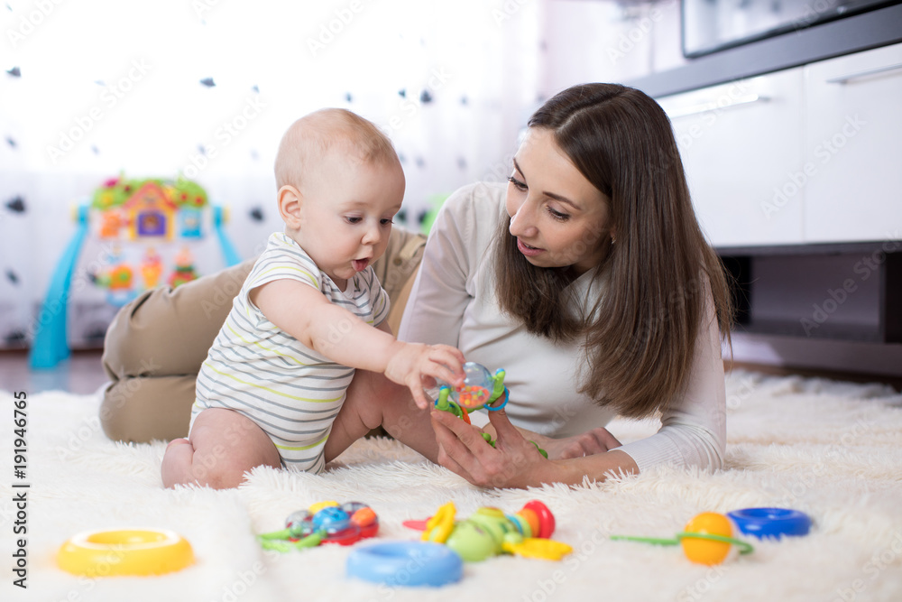 mom and her child playing with colorful logical toy mom and her child playing with colorful logical toy