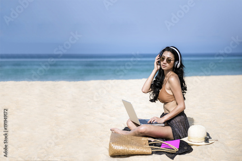 woman relax in vacation using laptop computer on the beach. Freelance work concep