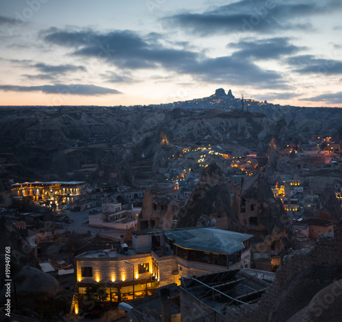 Night scene of the Uchisar Castle in Cappadocia. Illuminated view of famous Uchisar village, district of Nevsehir Province in the Central Anatolia Region of Turkey, Asia.