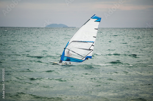 windsurfer floating on board at sea.