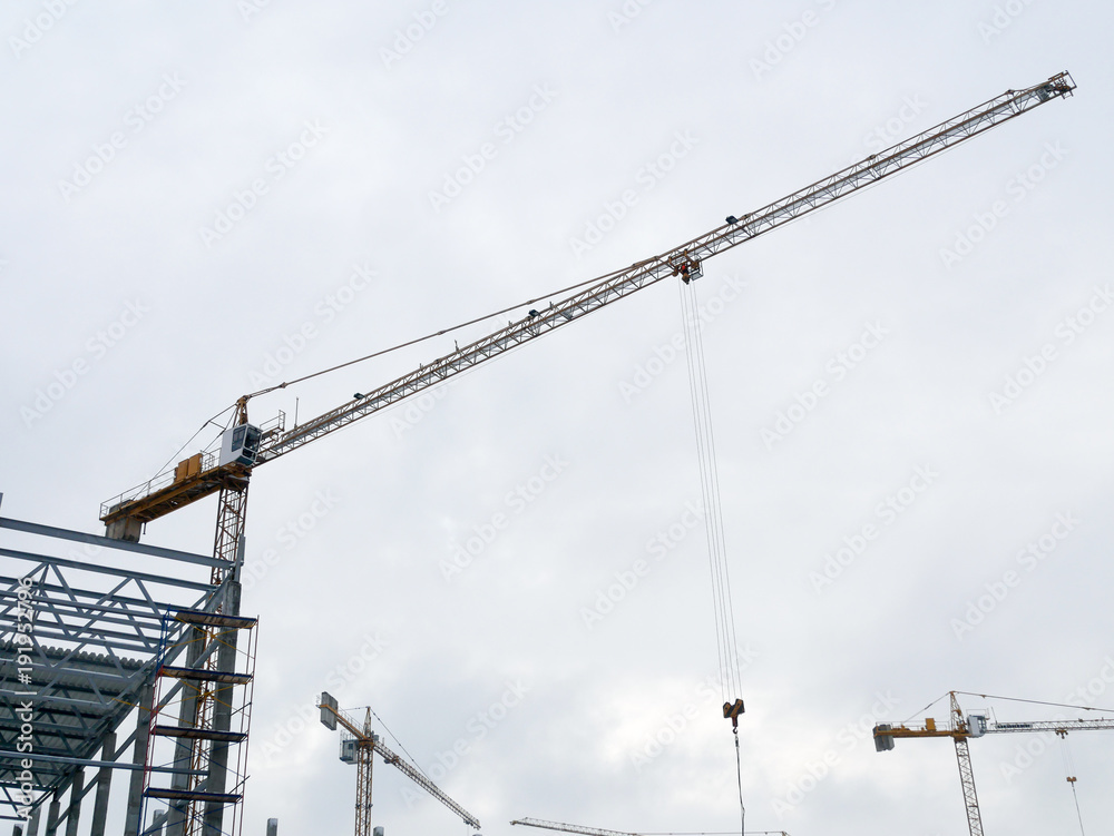 Construction crane working tower building