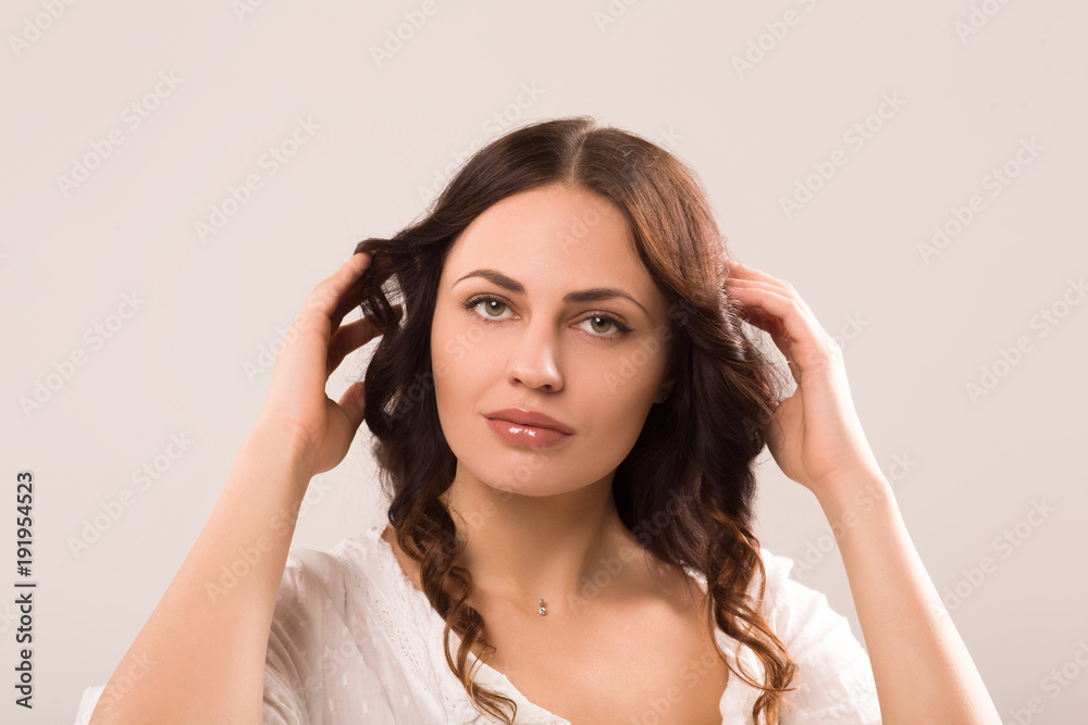 Beautiful girl with ideal face. Touching her hair. Beautiful girl with ideal face. Touching her hair.