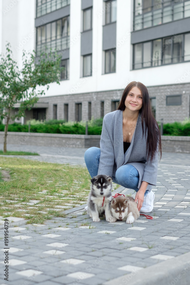 Smiling woman holding cute husky puppy Smiling woman holding cute husky puppy