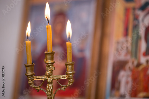candle against the background of orthodox icons