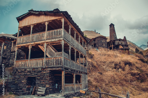 Traditional house in village Dartlo with stone defensive towers in Tusheti. Adventure holiday. Travel to Georgia. Green ecology tourism. Eco trekking tour. Balcony decorated with fretwork