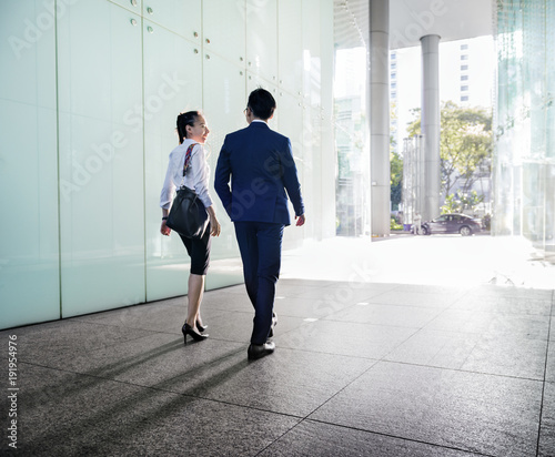 Photography Asian business people discussing while walking