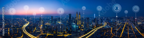 Panorama aerial view in the  cityscape skyline  with smart services and icons, internet of things, networks and augmented reality concept , early morning sunrise scene .