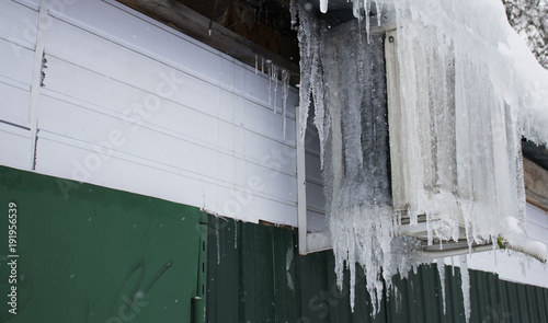 icicles hanging from the air conditioner close-up. frozen air conditioning on the building © Igorzvencom