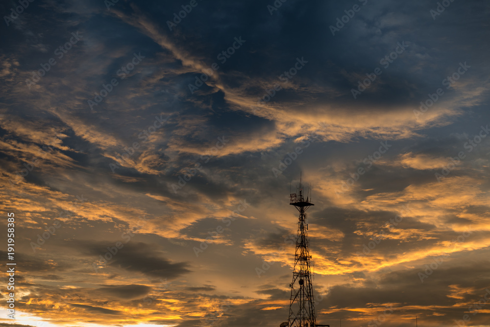 Silhouette of Signal Tower with beautiful Cloudy sunset sky background Silhouette of Signal Tower with beautiful Cloudy sunset sky background