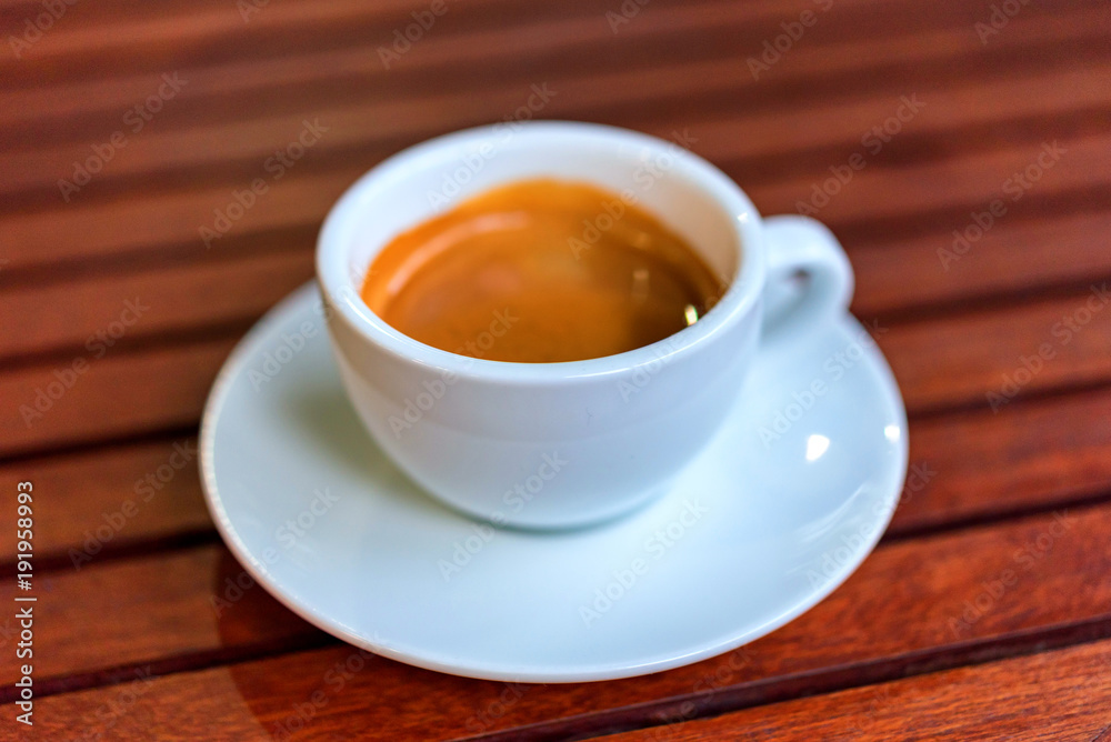 cup of coffee on the wooden table cup of coffee on the wooden table