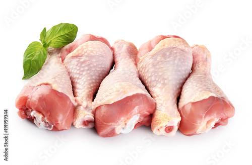 Raw chicken legs and basil isolated on white background.