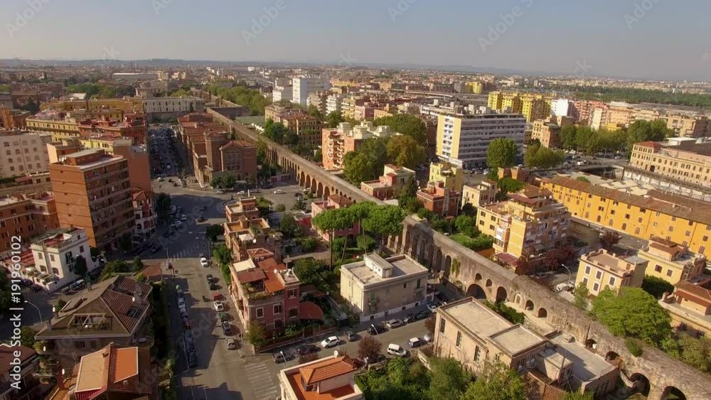 Aerial over Rome flying towards the ancient aqueduct running through the city Aerial over Rome flying towards the ancient aqueduct running through the city