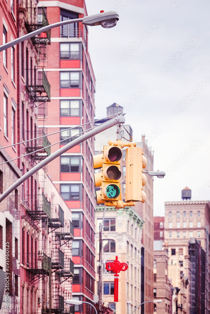 New York City traffic lights with buildings on background , color toned picture, USA.