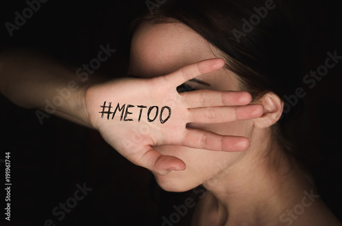 Girl covers her face with hand with hashtag metoo against harassment photo