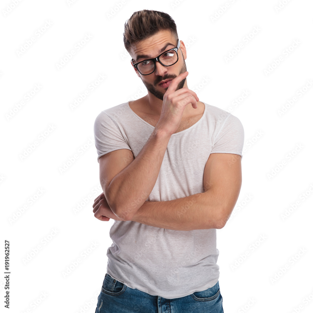 pensive man making a stupid face and looks to side