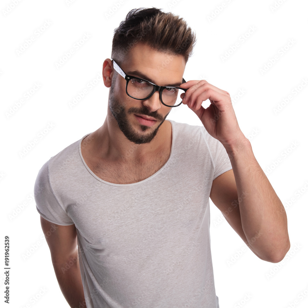 smiling casual man fixing his glasses smiling casual man fixing his glasses
