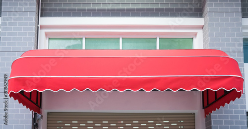 Canvas Print Red awning mounted on the front door of the shop.