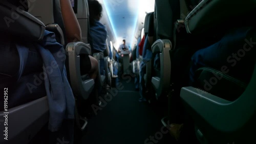 People riding on a bumpy commercial airline in seats with turbulence photo