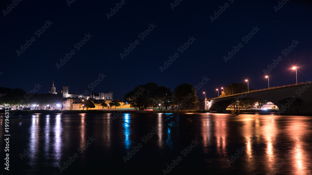 The Palace of Pope (Palais des Papes) in Avignon France night view with the  bridge over the Rhone river