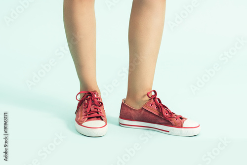 Women shoes. sports shoes ,sneakers. Closeup of woman legs and feet wearing red shoes
