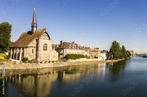 The Catholic church of Saint-Maurice in Sens, Burgundy, France, reflected in the river Yonne