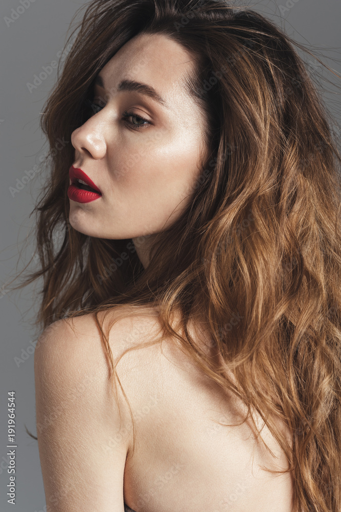Fashion portrait of a sensual shirtless curly brown hair woman Fashion portrait of a sensual shirtless curly brown hair woman
