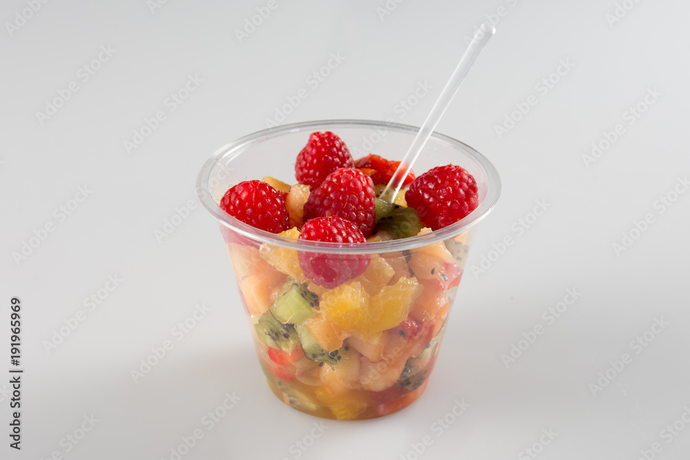 a fruit salad in take away clear plastic cup on white background a fruit salad in take away clear plastic cup on white background