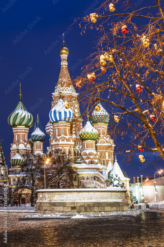 View of the Intercession Cathedral and colorful balls on the trees in the winter evening, Red square, Moscow, Russia