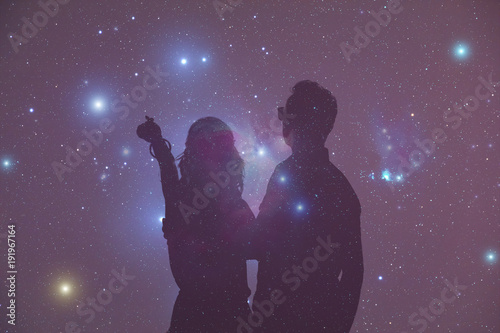 Young couple enjoying under the Milky Way stars. 