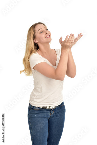 3/4 portrait of blonde girl wearing white shirt. isolated on white background.