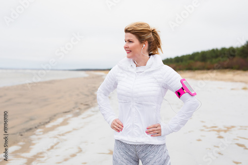 Fitness woman on th beach in winter