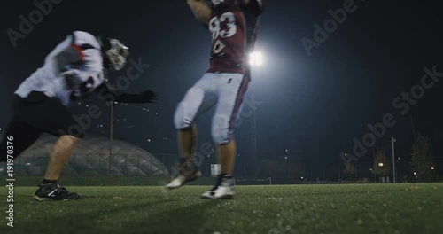 American football player tackles opponent