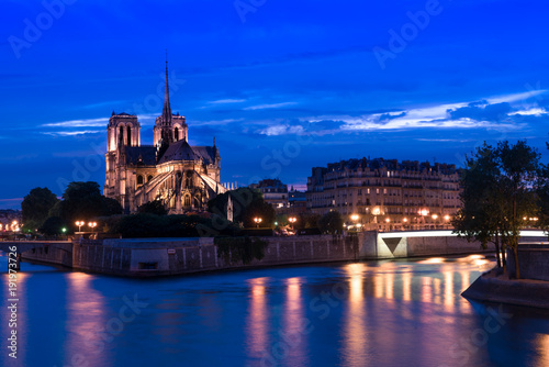 Notre-Dame Cathedral with light & Seine River at night