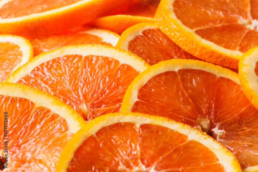 Fresh juicy orange fruit rings close up background. Fresh juicy orange fruit rings close up background.