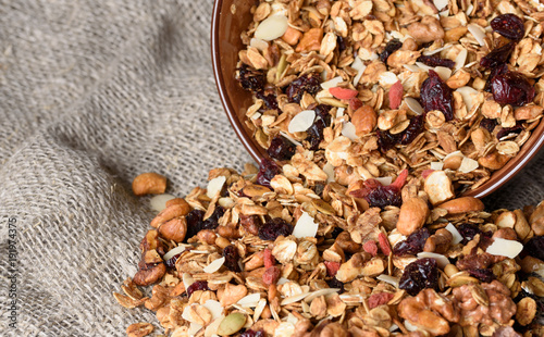 Granola from several types of cereals with nuts,coconut chips and dried cranberry. photo