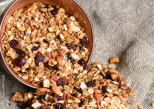 Granola from several types of cereals with nuts,coconut chips and dried cranberry. photo