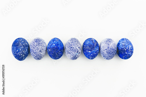 Blue Easter Eggs with copy space on white background. Flat lay. Top view