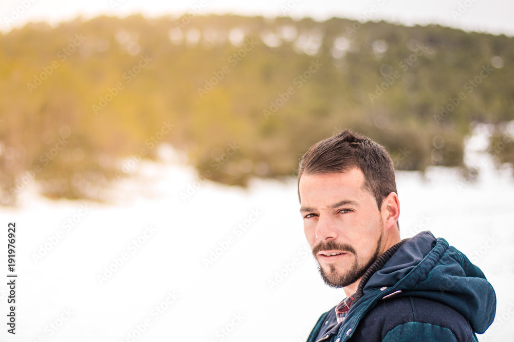 Young man with beard laughing in nature Young man with beard laughing in nature